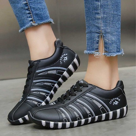 Sleek Black Athletic Sneakers with Classic White Stripes image