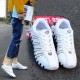 Sleek White Athletic Sneakers with Classic White Stripes image