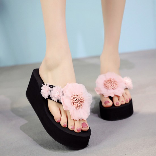 Black wedge slippers with vibrant pink floral embellishments