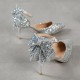 Elegant black glitter stiletto heel with pointed toe, ankle strap, and decorative bow for women